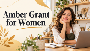 Woman entrepreneur at a desk in a creative studio beside the words “Amber Grant for Women.”